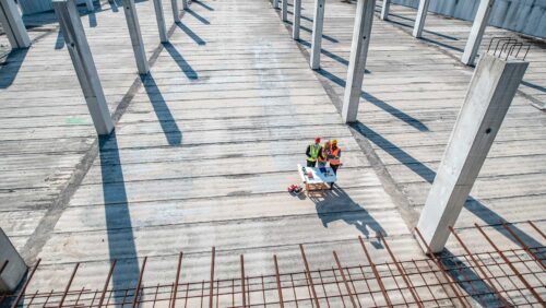 aerial view of building construction and workers