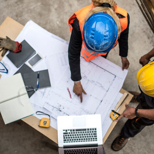 construction workers looking over blueprints.