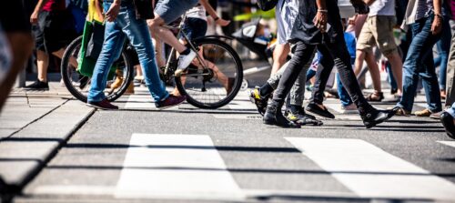crosswalk with people walking and biking