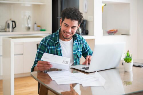 happy guy checking over bills