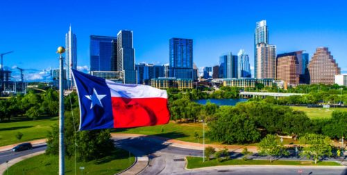 Texas flag in front of city