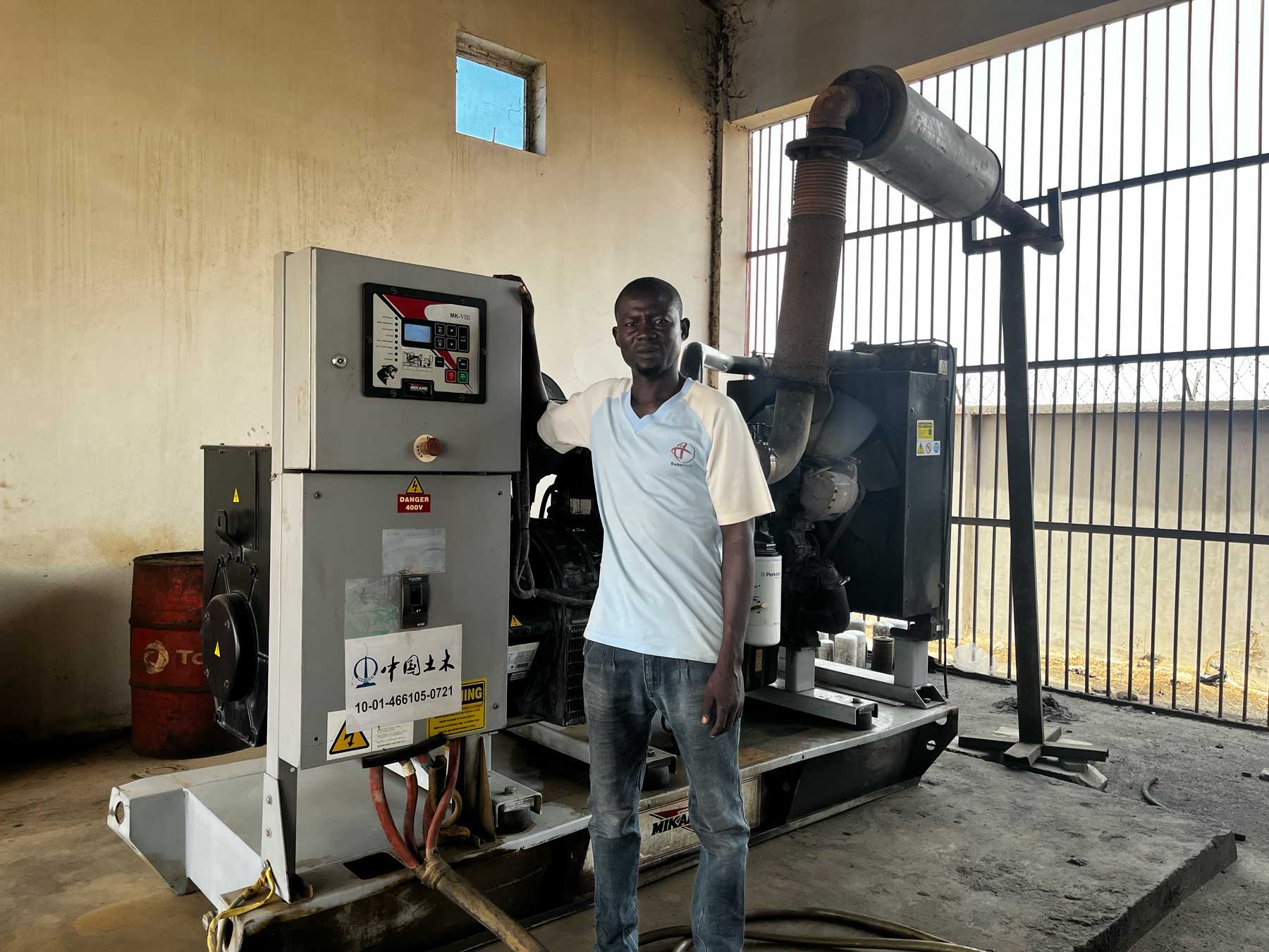 CCECC generator technician with the idle diesel generators.