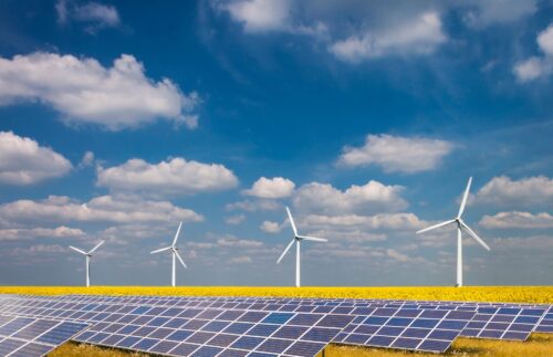 solar panel array beside wind turbines