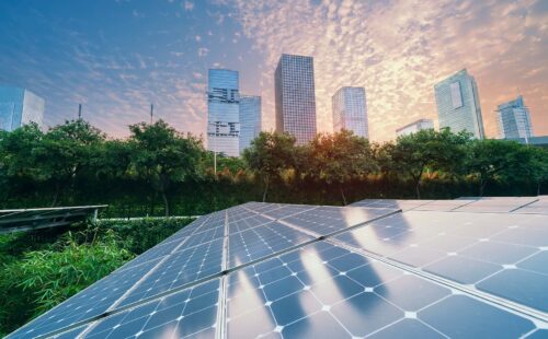 solar panels with view of city in background
