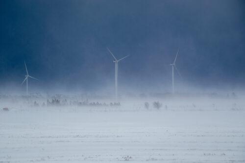 winter storm covering wind turbines