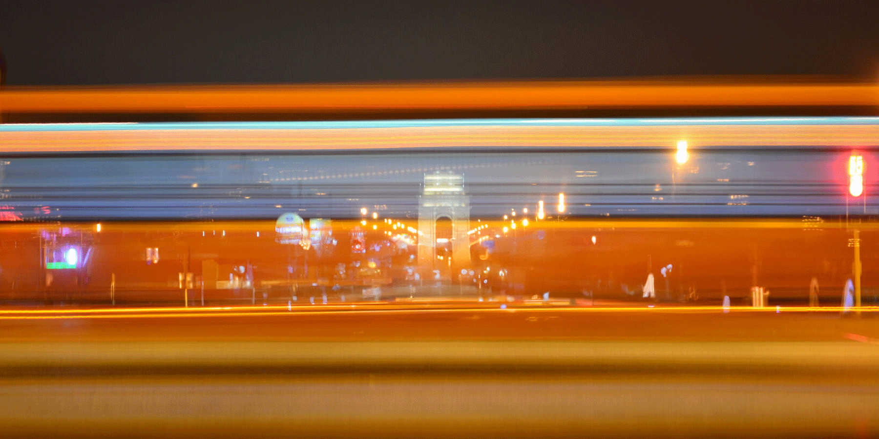 Motion blur of vehicle lights in front of the India Gate in New Dehli, India.